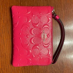 Neon pink Coach wristlet